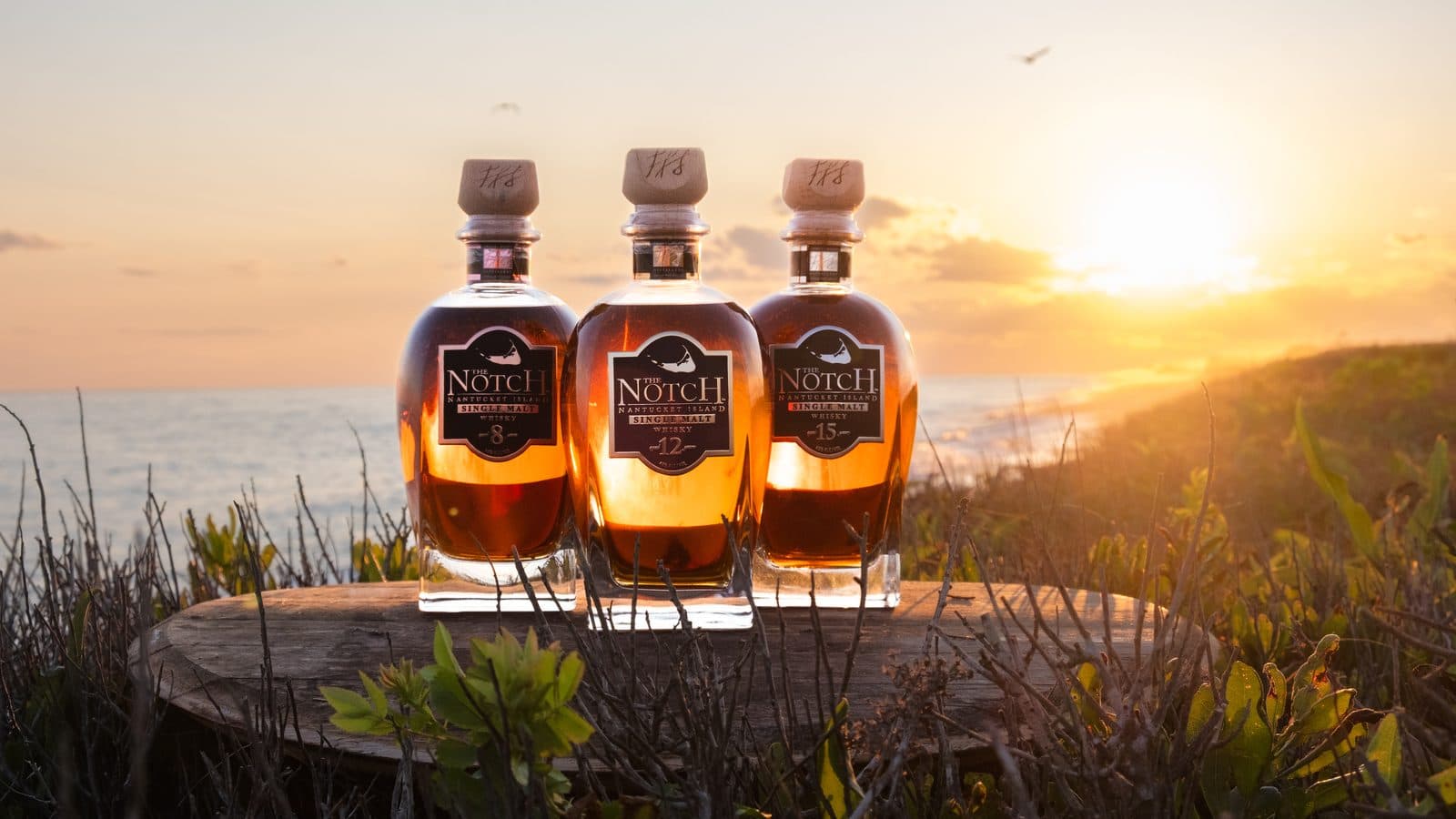The Notch single malt whiskey bottles photographed at sunset on Nantucket by Owen Hudson for Triple Eight Distillery